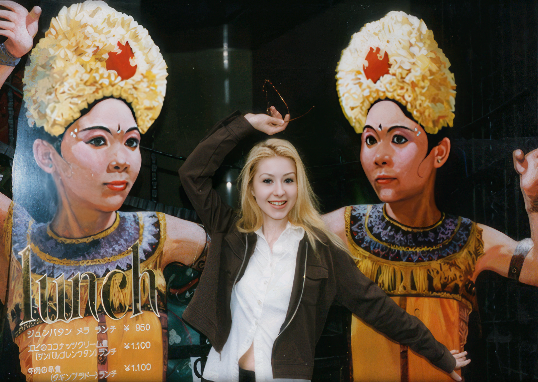 Christina posing in front of a giant poster in japan, age 15.
