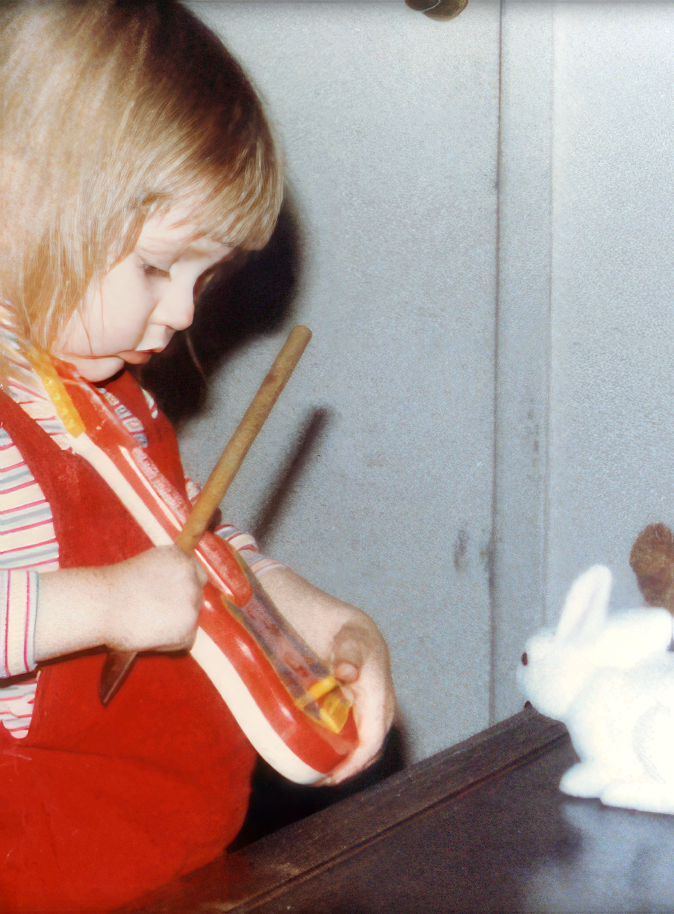 Christina playing violin on her toy guitar at age 2 1/2 -- notice the stuffed animal audience
Christina playing violin on her toy guitar at age 2 1/2 -- notice the stuffed animal audience