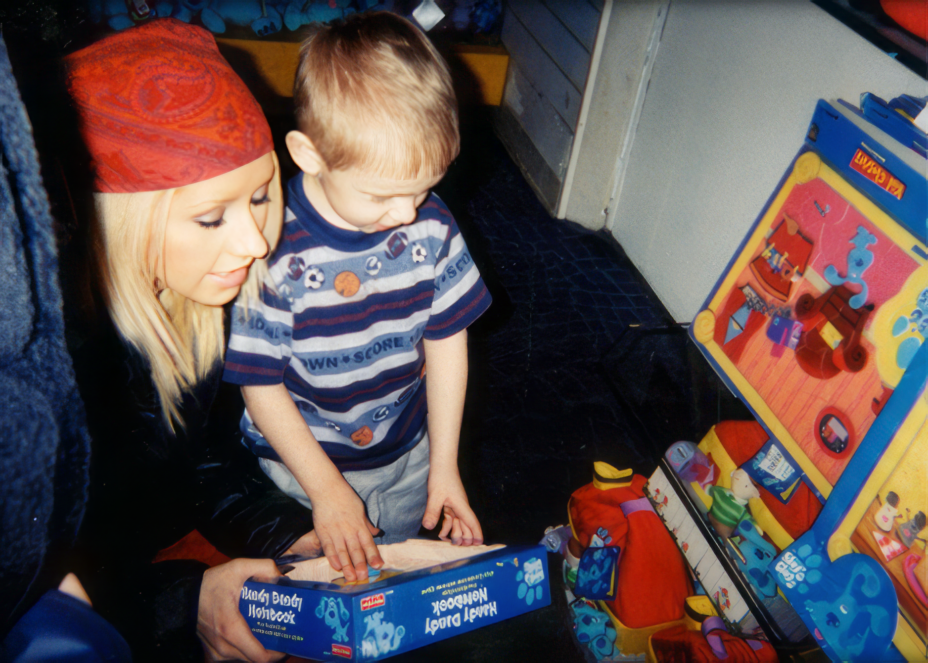 Christina, age 18, showing toys to her little brother Mikey at FAO Schwartz in New York City.

