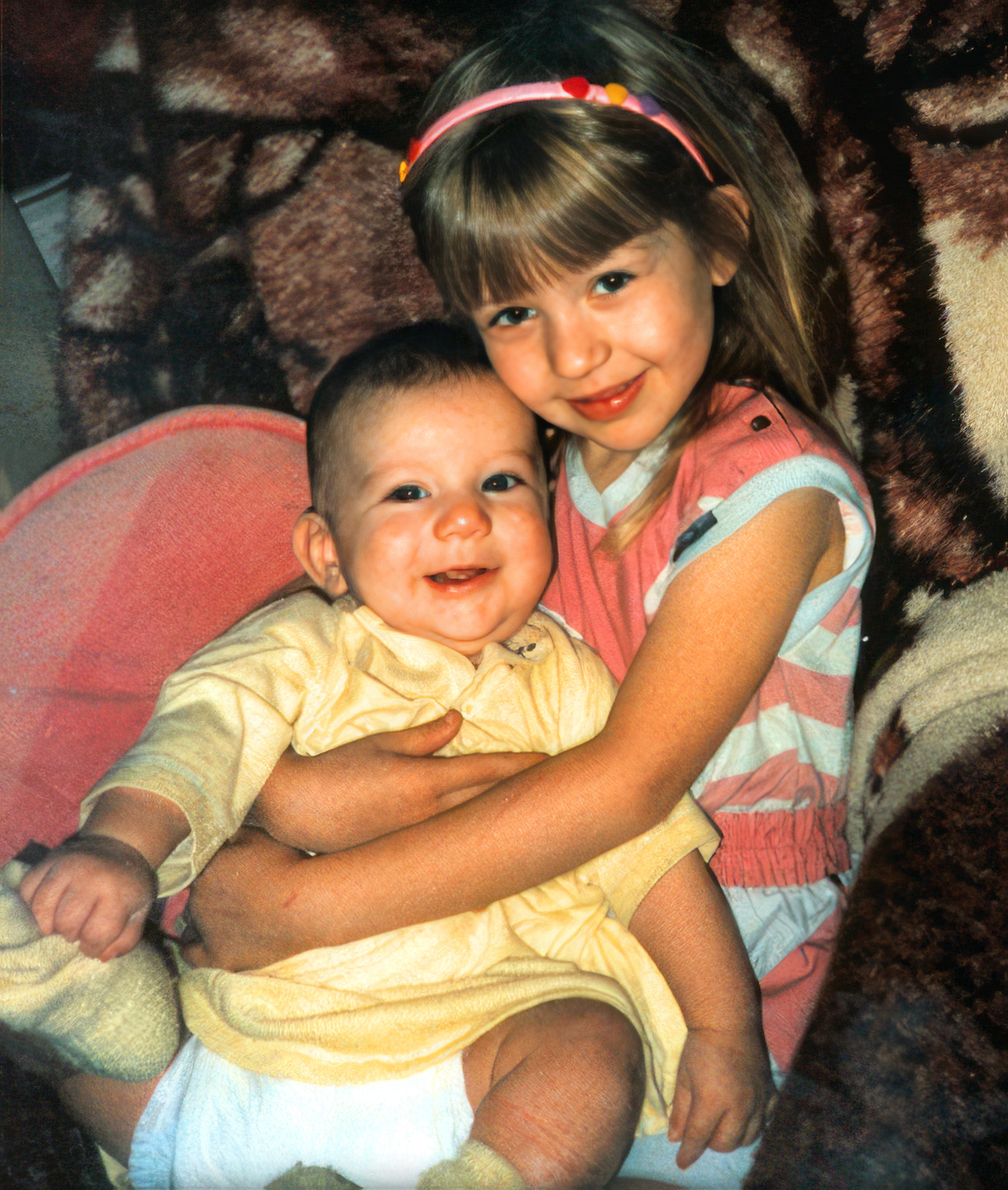 Christina, age 5, holding her 7 month younger sister Rachel.
