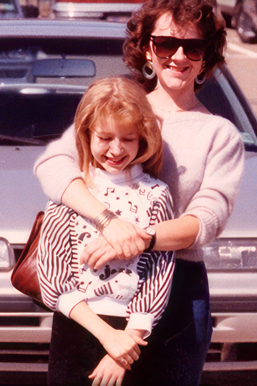Mom and Christina, age 12 in a mall parking lot.
